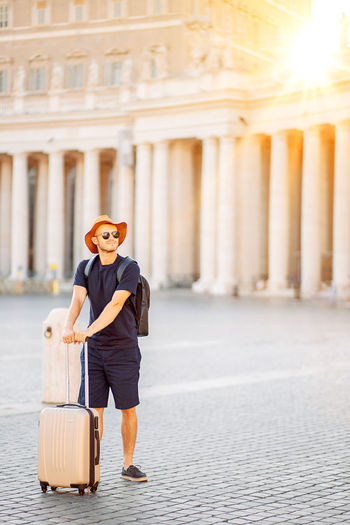 Young man tourist in rome at vatican city on vacation, an emigrant. moving to a new country.