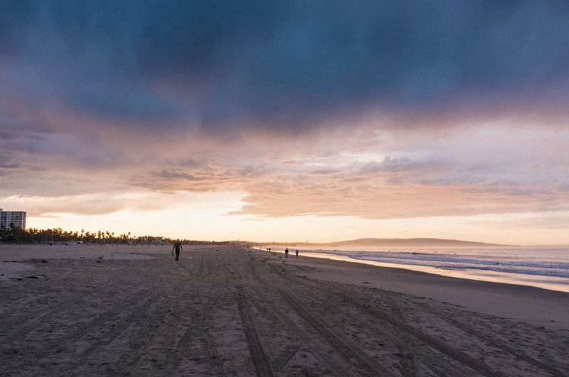 Scenic view of beach against sky during sunset
