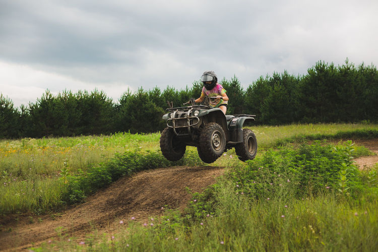 Teen girl catching air on atv track in northwestern wi