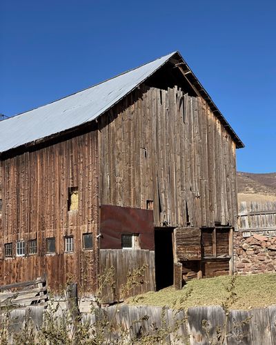 Old barn on building against sky