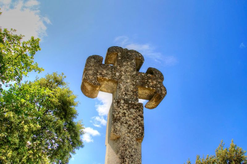 Low angle view of statue against blue sky