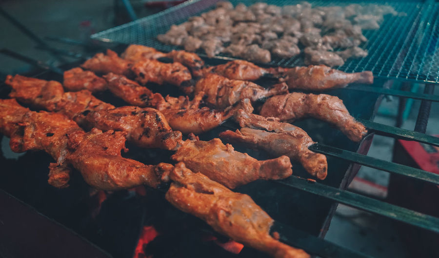 High angle view of meat on barbecue grill