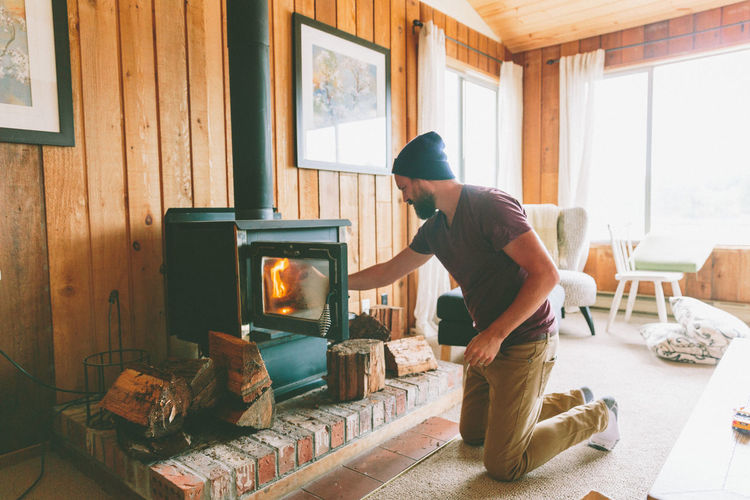 Man burning firewood at home