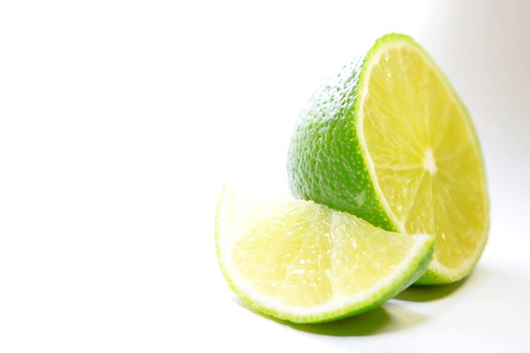 Close-up of lemon slice against white background