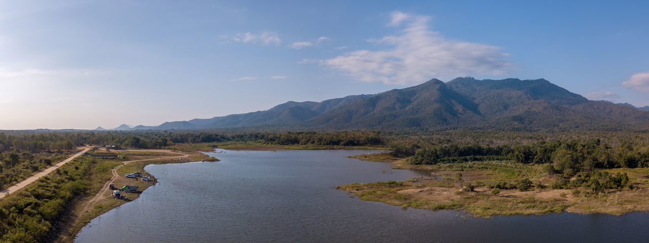 Scenic view of river amidst mountains against sky