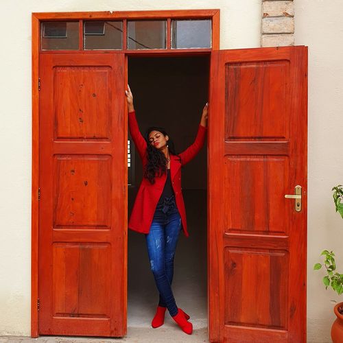 Full length of woman standing at doorway