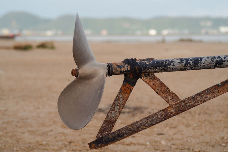 Close-up of rusty metal on beach