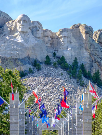Flags against mt rushmore national monument