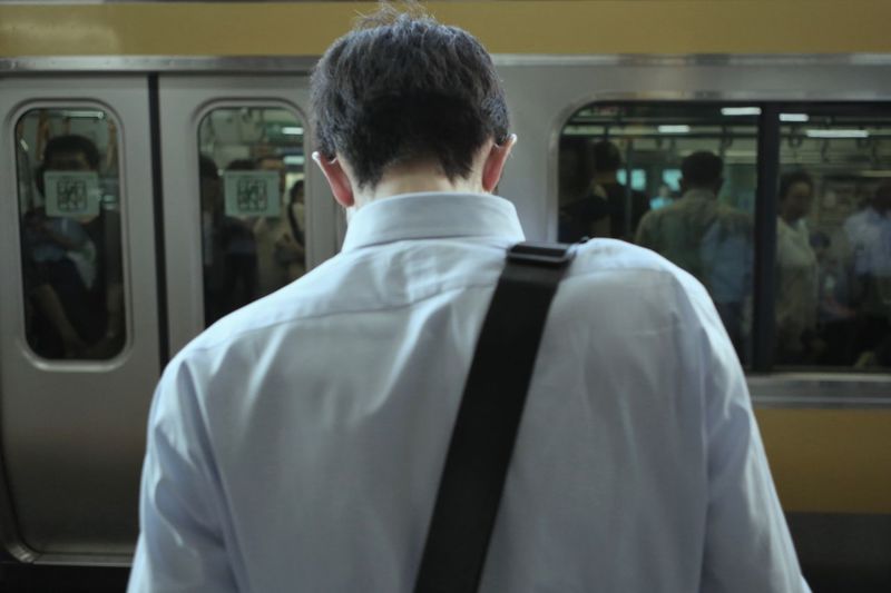 Rear view of people standing in train