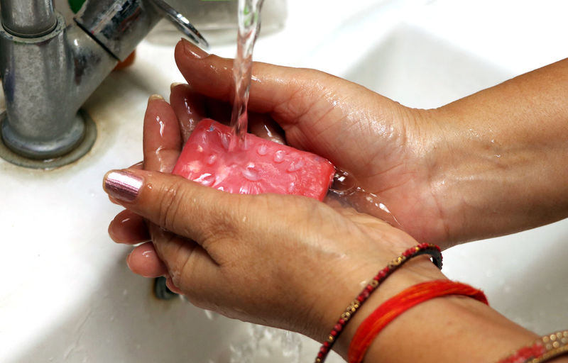 Cropped hand of person washing hands