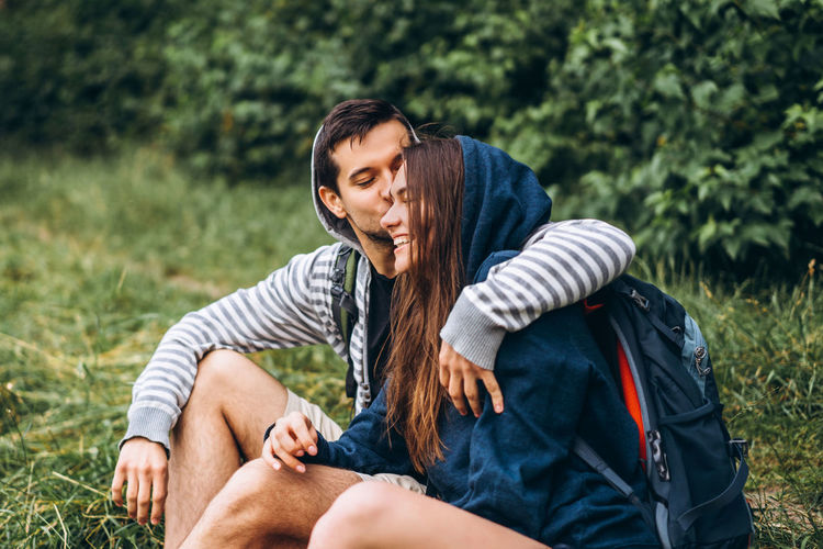 Rear view of couple sitting on land