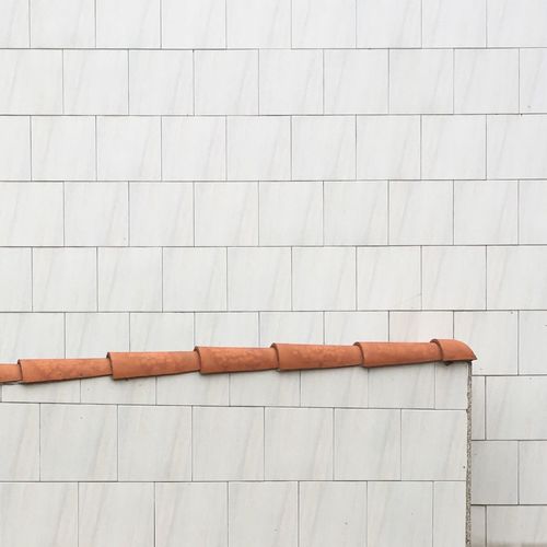 Close-up of white tiled wall