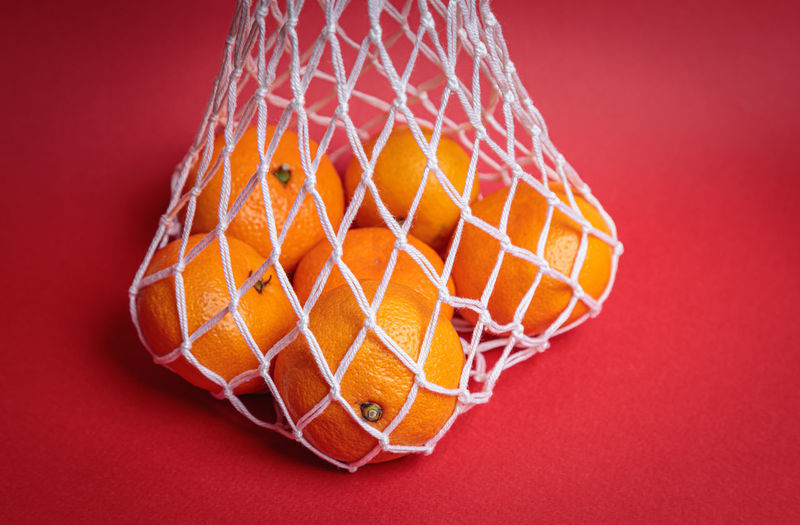 Close-up of basketball hoop against yellow background