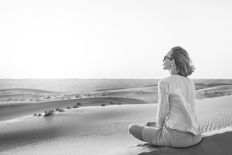 Woman sitting in desert