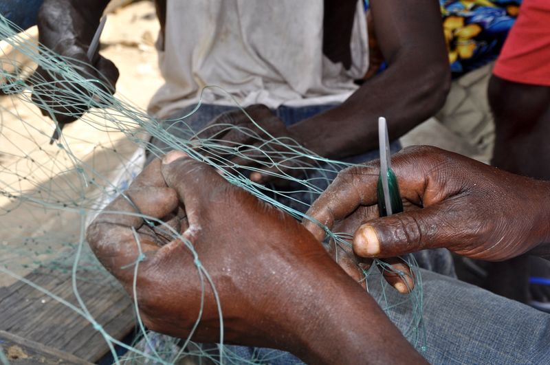 Cropped image of hands making fishing net