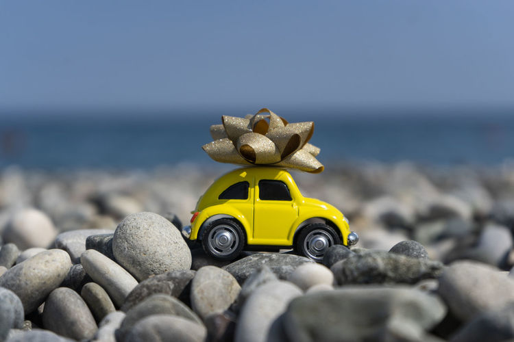 Close-up of toy car on beach