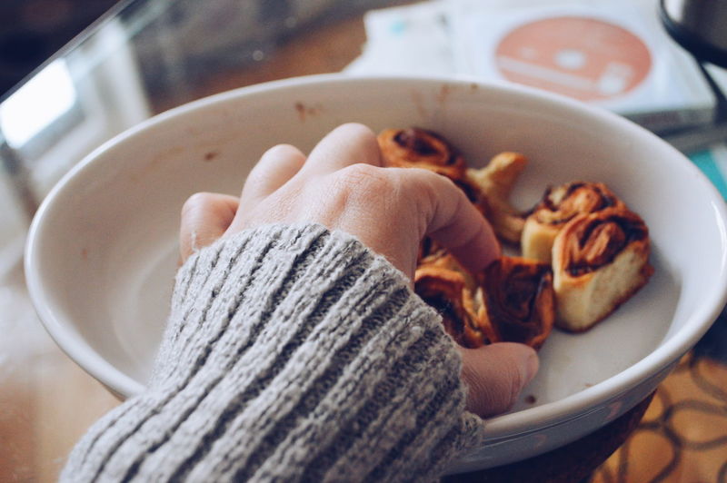 Cropped image of hand holding food