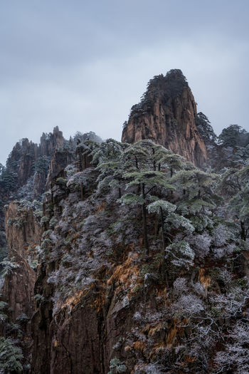 Low angle view of rock formation against sky