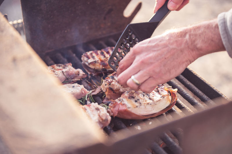 Man grilling meat on barbecue