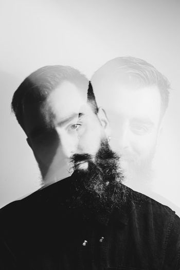 Double exposure image of man against white background