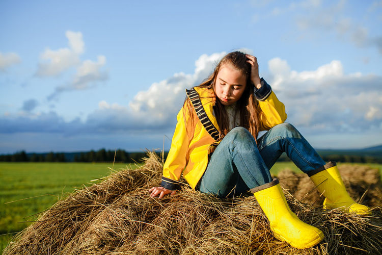 Young woman sitting on field