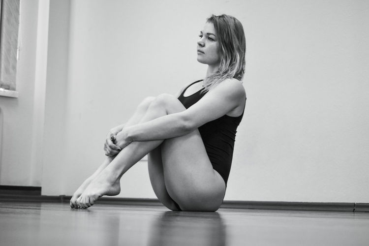 Young woman sitting on floor