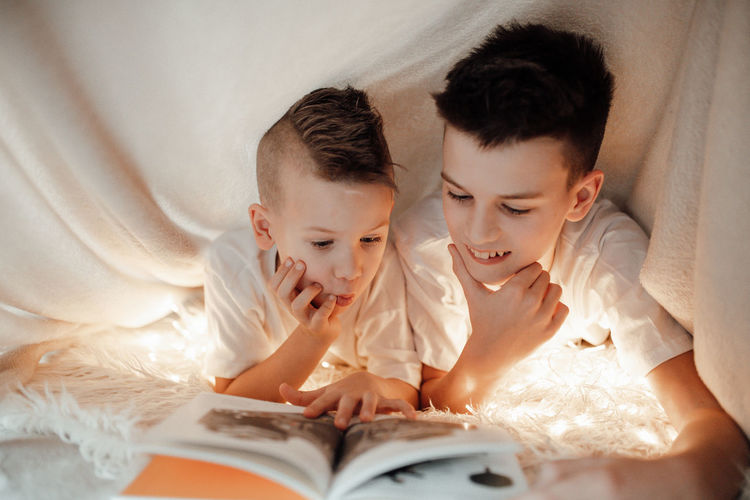 Boy lying on bed