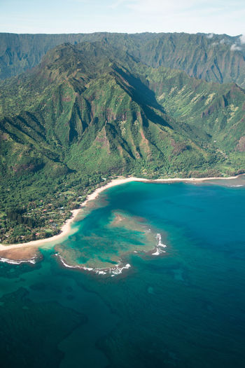 Scenic view of rock mountains by sea