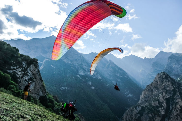 People paragliding over mountains