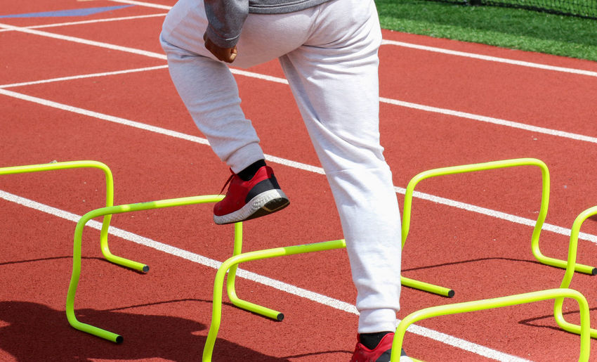Low section of man exercising on field