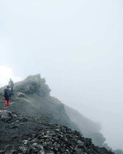 A group of hikers above the clouds at mount meru, arusha national park, tanzania