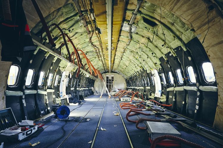 Interior of commercial airplane under heavy maintenance. 