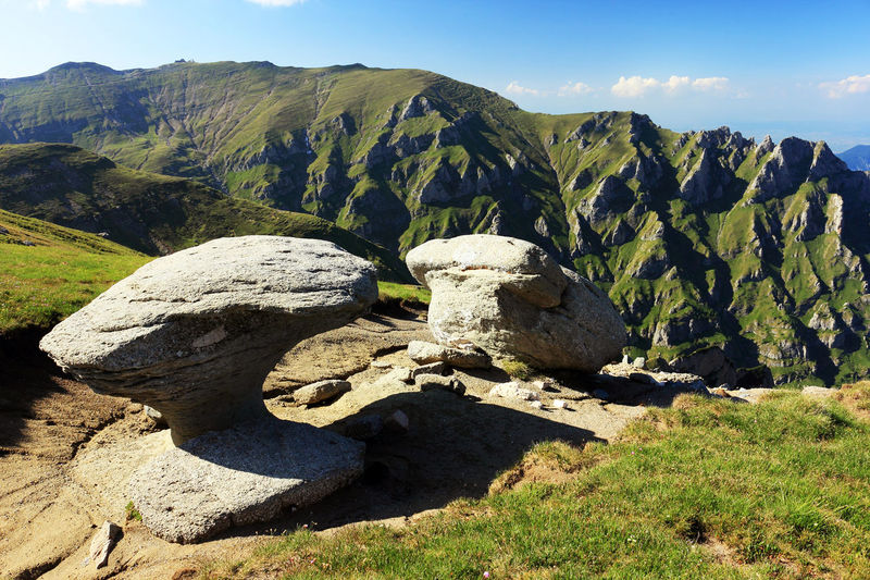 Rock formations by mountains at bucegi natural park
