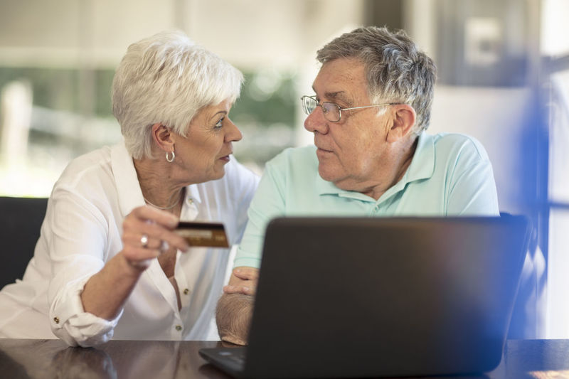 Senior couple shopping online with credit card