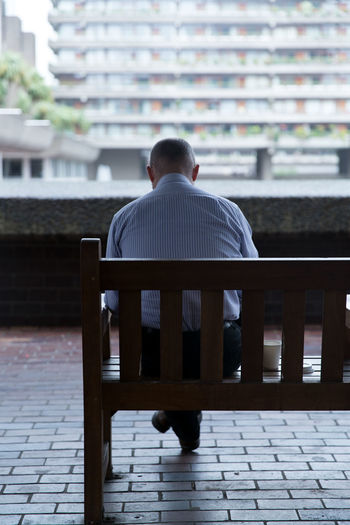 Rear view of man sitting outdoors