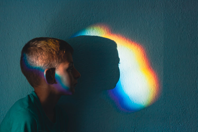 Portrait of man against illuminated wall