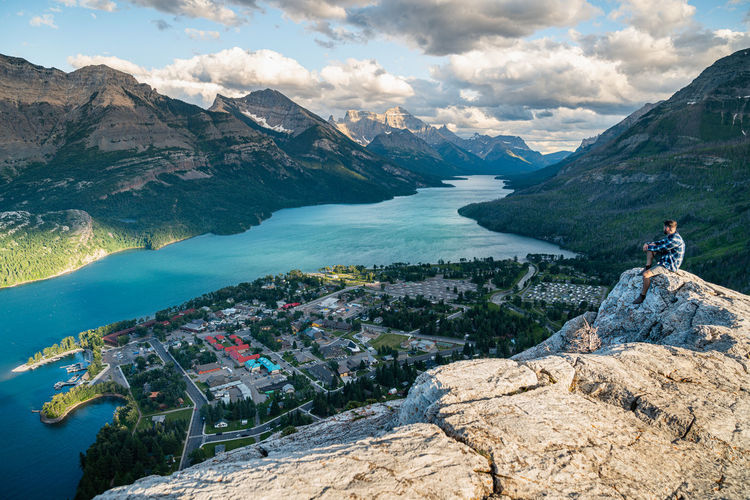 Hiker watching the sunset over waterton national park in alberta