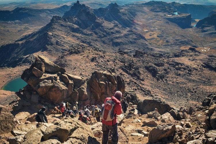 A group of hikers in the panoramic volcanic mountain landscapes of mount kenya, kenya