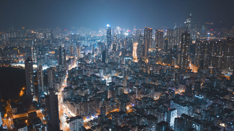Illuminated cityscape against sky at night