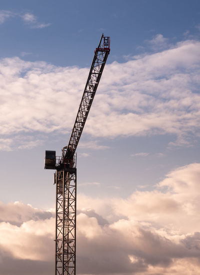 Low angle view of crane against sky