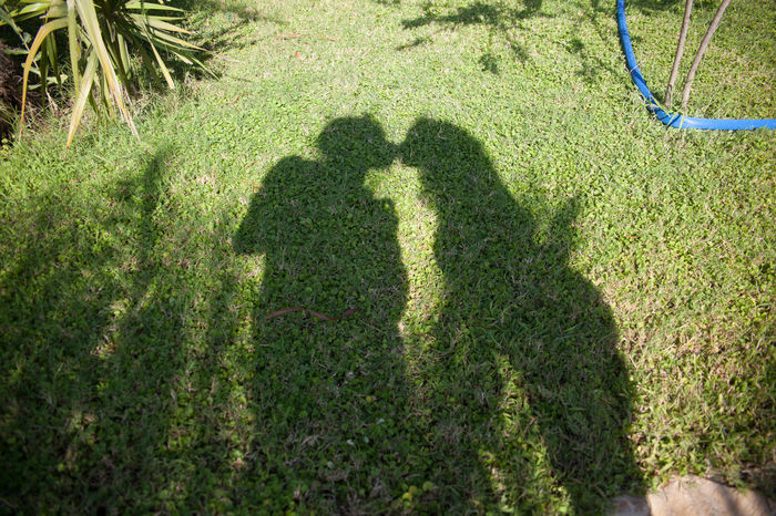 Shadow of couple kissing in park