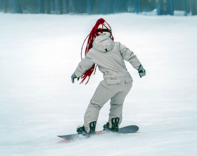 Low angle view of man skiing on snow covered field