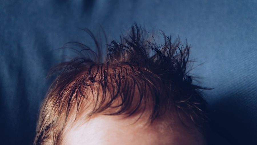 Cropped image of boy hair at home