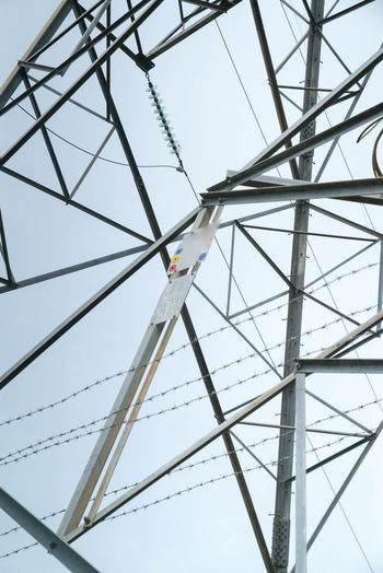 Close-up low angle view of cropped electricity pylon