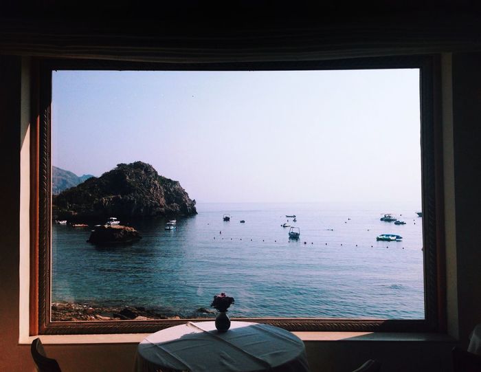 Scenic view of sea against sky seen from window at restaurant