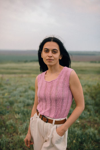 Portrait of woman standing in field