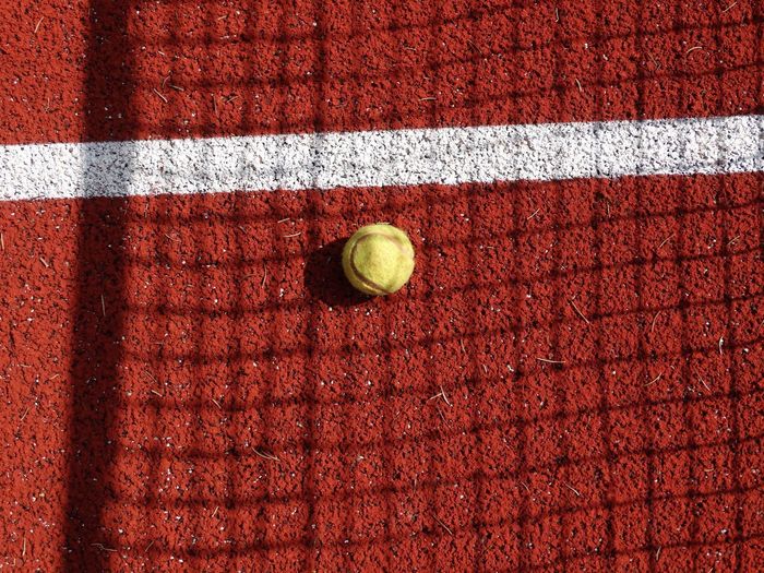 Tennis ball on clay court