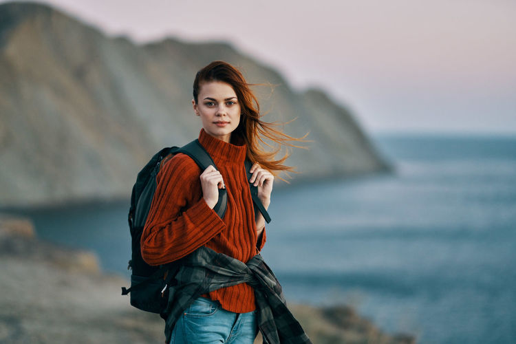 Portrait of beautiful young woman standing in sea