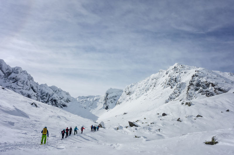 People climbing on snowcapped mountains
