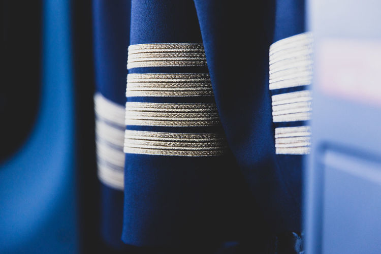 Full frame shot of pilots jackets hanging in wardrobe